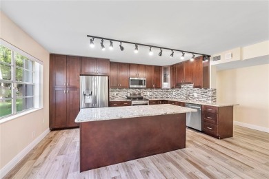 Beautifully renovated 3-bedroom, 2-bathroom corner unit in Holly on Woodmont Country Club in Florida - for sale on GolfHomes.com, golf home, golf lot