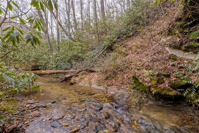 Enjoy a private 0.75-acre setting with the year-round sounds of on Sapphire National Golf Club in North Carolina - for sale on GolfHomes.com, golf home, golf lot