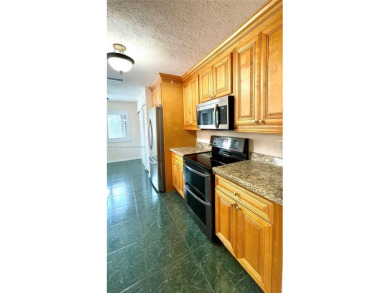 Discover this beautifully upgraded 2-bedroom, 2-bath corner unit on Pine Island Ridge Country Club in Florida - for sale on GolfHomes.com, golf home, golf lot