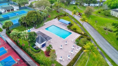 BRIGHT & SPACIOUS CORNER OVERLOOKING THE POOL AREA & SURROUNDING on Wynmoor Golf Course in Florida - for sale on GolfHomes.com, golf home, golf lot
