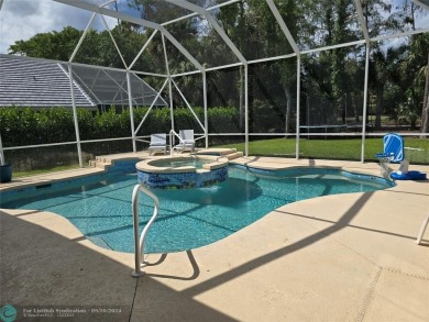 Desirable Grand Cayman model with Screened-in pool with spa on Binks Forest Golf Club in Florida - for sale on GolfHomes.com, golf home, golf lot