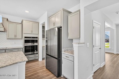 Experience elevated coastal living in this luxury 4-bedroom home on Crow Creek Golf Club in North Carolina - for sale on GolfHomes.com, golf home, golf lot