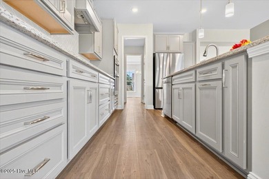 Experience elevated coastal living in this luxury 4-bedroom home on Crow Creek Golf Club in North Carolina - for sale on GolfHomes.com, golf home, golf lot