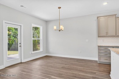 Experience elevated coastal living in this luxury 4-bedroom home on Crow Creek Golf Club in North Carolina - for sale on GolfHomes.com, golf home, golf lot