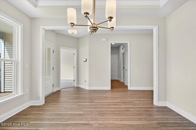 Experience elevated coastal living in this luxury 4-bedroom home on Crow Creek Golf Club in North Carolina - for sale on GolfHomes.com, golf home, golf lot