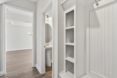 Experience elevated coastal living in this luxury 4-bedroom home on Crow Creek Golf Club in North Carolina - for sale on GolfHomes.com, golf home, golf lot