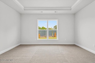 Experience elevated coastal living in this luxury 4-bedroom home on Crow Creek Golf Club in North Carolina - for sale on GolfHomes.com, golf home, golf lot