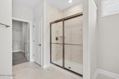 Experience elevated coastal living in this luxury 4-bedroom home on Crow Creek Golf Club in North Carolina - for sale on GolfHomes.com, golf home, golf lot