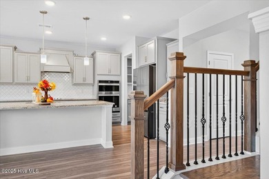 Experience elevated coastal living in this luxury 4-bedroom home on Crow Creek Golf Club in North Carolina - for sale on GolfHomes.com, golf home, golf lot