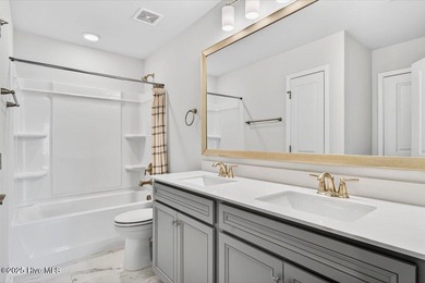 Experience elevated coastal living in this luxury 4-bedroom home on Crow Creek Golf Club in North Carolina - for sale on GolfHomes.com, golf home, golf lot