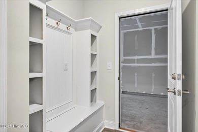 Experience elevated coastal living in this luxury 4-bedroom home on Crow Creek Golf Club in North Carolina - for sale on GolfHomes.com, golf home, golf lot