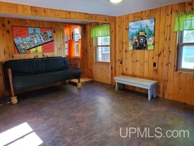 Enjoy the quaint rustic ambience of this northwoods cottage on Wyandotte Hills Golf Course in Michigan - for sale on GolfHomes.com, golf home, golf lot