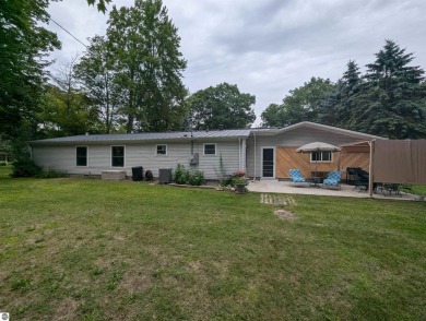 An immaculate home with deeded beach access along Lake Huron in on Singing Bridge Golf Course in Michigan - for sale on GolfHomes.com, golf home, golf lot