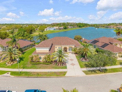 Experience lakeside living in this magnificent lakefront home in on Venetian Bay Golf Course in Florida - for sale on GolfHomes.com, golf home, golf lot