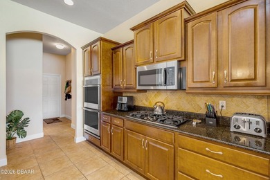 Experience lakeside living in this magnificent lakefront home in on Venetian Bay Golf Course in Florida - for sale on GolfHomes.com, golf home, golf lot