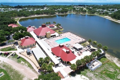 Coastal style home features metal roof & newer A/C and Golf on Barefoot Bay Golf Course in Florida - for sale on GolfHomes.com, golf home, golf lot