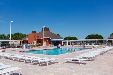 Coastal style home features metal roof & newer A/C and Golf on Barefoot Bay Golf Course in Florida - for sale on GolfHomes.com, golf home, golf lot