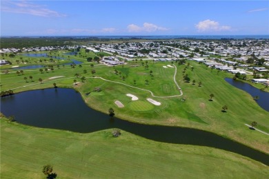 Coastal style home features metal roof & newer A/C and Golf on Barefoot Bay Golf Course in Florida - for sale on GolfHomes.com, golf home, golf lot