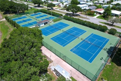 Coastal style home features metal roof & newer A/C and Golf on Barefoot Bay Golf Course in Florida - for sale on GolfHomes.com, golf home, golf lot