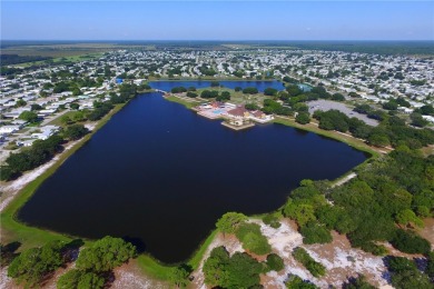 Coastal style home features metal roof & newer A/C and Golf on Barefoot Bay Golf Course in Florida - for sale on GolfHomes.com, golf home, golf lot