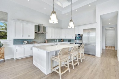 This stunning single-story residence, built in 2023, showcases on The Golf Club At Fiddlers Creek in Florida - for sale on GolfHomes.com, golf home, golf lot