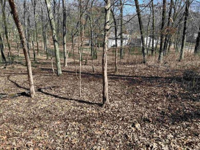 This wooded 0.52 acre lot overlooks the picturesque view of the on Diamondhead Golf and Country Club in Arkansas - for sale on GolfHomes.com, golf home, golf lot