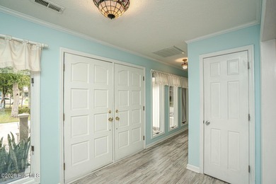 Spacious Coastal Retreat with Sunroom & Outdoor Entertaining on Brick Landing Plantation Yacht and Golf Club in North Carolina - for sale on GolfHomes.com, golf home, golf lot