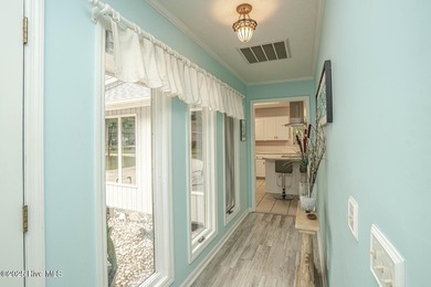 Spacious Coastal Retreat with Sunroom & Outdoor Entertaining on Brick Landing Plantation Yacht and Golf Club in North Carolina - for sale on GolfHomes.com, golf home, golf lot