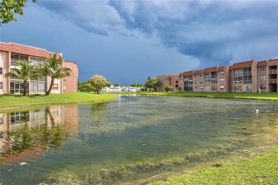 Wake up to tranquil water views in this stunning 2-bedroom on Sunrise Lakes Phase III in Florida - for sale on GolfHomes.com, golf home, golf lot