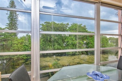 Wake up to tranquil water views in this stunning 2-bedroom on Sunrise Lakes Phase III in Florida - for sale on GolfHomes.com, golf home, golf lot