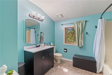 Set on a gently sloping, beautifully landscaped lot in a quiet on Holiday Island Executive Golf Course in Arkansas - for sale on GolfHomes.com, golf home, golf lot