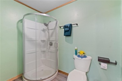 Set on a gently sloping, beautifully landscaped lot in a quiet on Holiday Island Executive Golf Course in Arkansas - for sale on GolfHomes.com, golf home, golf lot