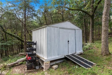 Set on a gently sloping, beautifully landscaped lot in a quiet on Holiday Island Executive Golf Course in Arkansas - for sale on GolfHomes.com, golf home, golf lot