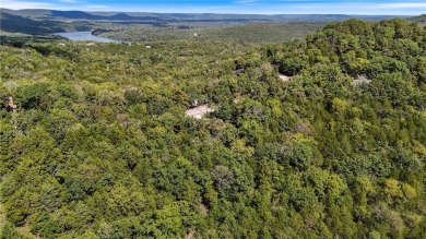 Set on a gently sloping, beautifully landscaped lot in a quiet on Holiday Island Executive Golf Course in Arkansas - for sale on GolfHomes.com, golf home, golf lot