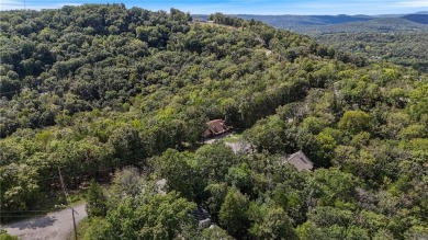 Set on a gently sloping, beautifully landscaped lot in a quiet on Holiday Island Executive Golf Course in Arkansas - for sale on GolfHomes.com, golf home, golf lot