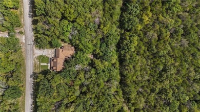 Set on a gently sloping, beautifully landscaped lot in a quiet on Holiday Island Executive Golf Course in Arkansas - for sale on GolfHomes.com, golf home, golf lot