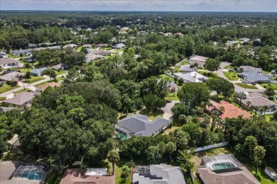 Spectacular concrete block pool home tucked at the end of a on The Grand Club - Pine Lakes Course in Florida - for sale on GolfHomes.com, golf home, golf lot