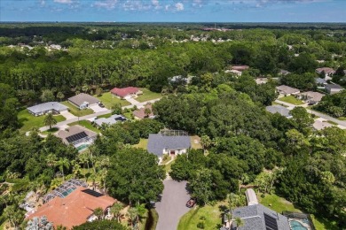 Spectacular concrete block pool home tucked at the end of a on The Grand Club - Pine Lakes Course in Florida - for sale on GolfHomes.com, golf home, golf lot