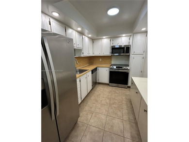 Discover comfort and convenience in this bright 2-bedroom condo on Pembroke Lakes Golf Club in Florida - for sale on GolfHomes.com, golf home, golf lot