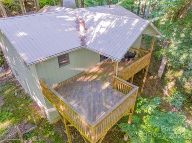 A charming cottage tucked away in the woods with plenty of light on Wolf Laurel Country Club in North Carolina - for sale on GolfHomes.com, golf home, golf lot