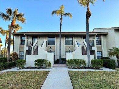 Well maintained END UNIT with WATER VIEW, spacious HIGH CEILINGS on The Meadows Golf and Country Club in Florida - for sale on GolfHomes.com, golf home, golf lot