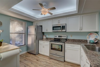 Well maintained END UNIT with WATER VIEW, spacious HIGH CEILINGS on The Meadows Golf and Country Club in Florida - for sale on GolfHomes.com, golf home, golf lot