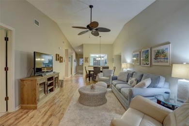 Well maintained END UNIT with WATER VIEW, spacious HIGH CEILINGS on The Meadows Golf and Country Club in Florida - for sale on GolfHomes.com, golf home, golf lot