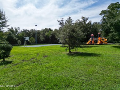 This fantastic lot features numerous adolescent oak trees on The Bridges Golf Club At Hollywood Casino in Mississippi - for sale on GolfHomes.com, golf home, golf lot