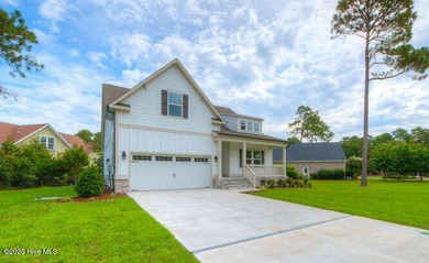 Welcome to this beautifully appointed 4-bedroom, 3-bath home on Carolina National Golf Club in North Carolina - for sale on GolfHomes.com, golf home, golf lot