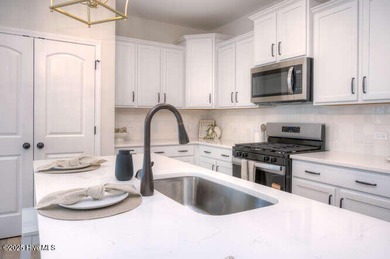 Welcome to this beautifully appointed 4-bedroom, 3-bath home on Carolina National Golf Club in North Carolina - for sale on GolfHomes.com, golf home, golf lot