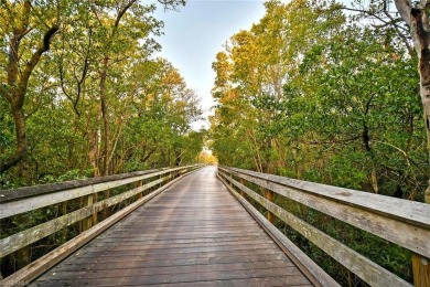 Discover refined coastal living in this rarely available on Club at Pelican Bay Golf Course in Florida - for sale on GolfHomes.com, golf home, golf lot