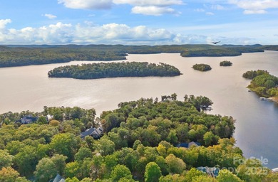 Embrace lake life at its finest in this truly exceptional on Old North State Club at Uwharrie Point Golf community in North Carolina - for sale on GolfHomes.com, golf home, golf lot