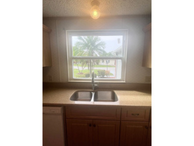**Beautiful Home on the 17th green in Pine Lakes Country Club** on Pine Lakes Country Club in Florida - for sale on GolfHomes.com, golf home, golf lot
