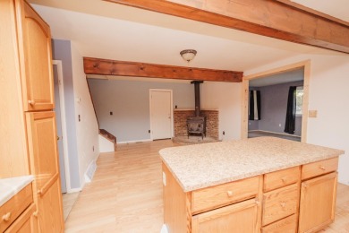 Discover the perfect retreat in this cozy chalet, ideally on Burning Oak Country Club in Michigan - for sale on GolfHomes.com, golf home, golf lot